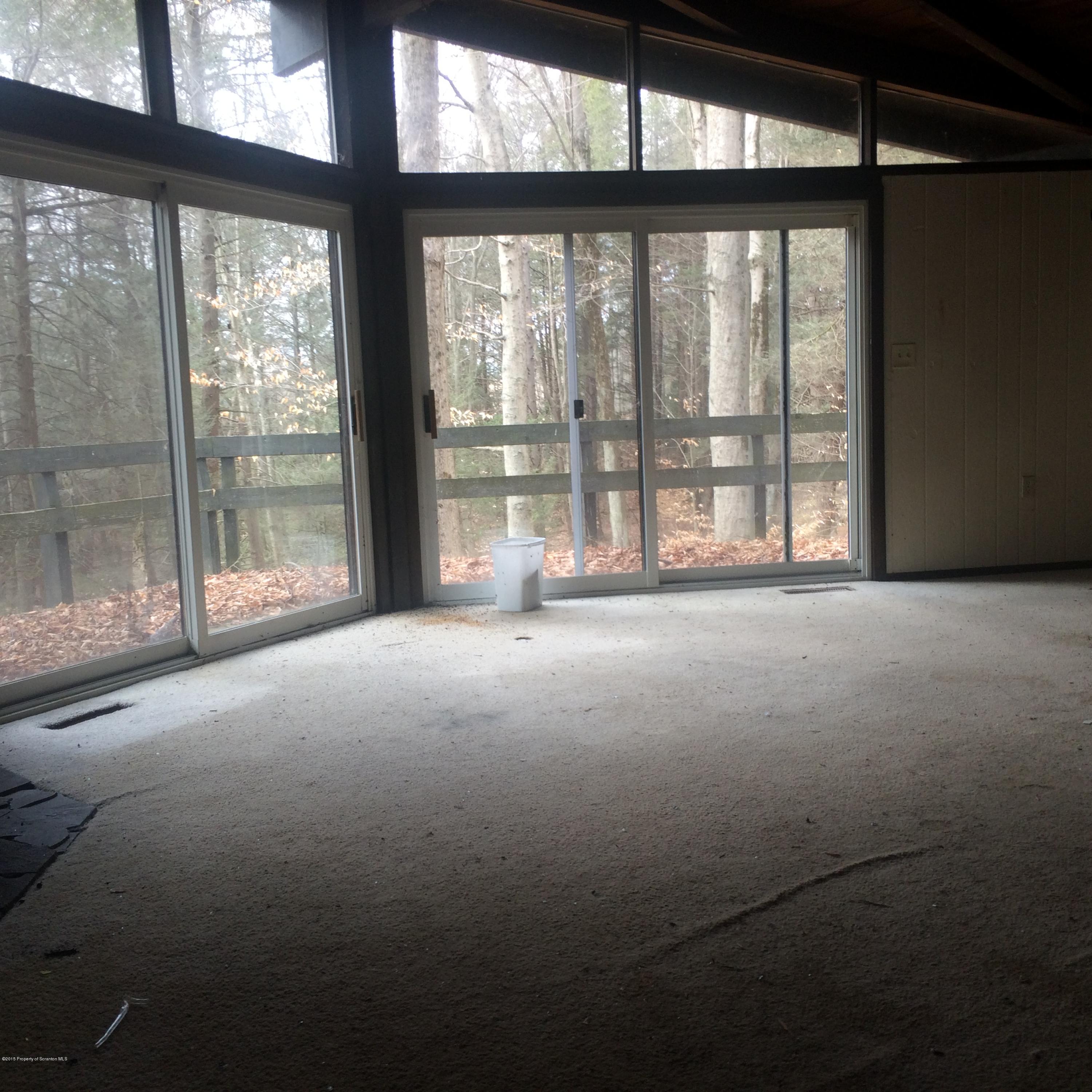 3322 Whengreen Road Nicholson, PA 18446 - Photo 8 of 15 a living room with large windows with balcony view