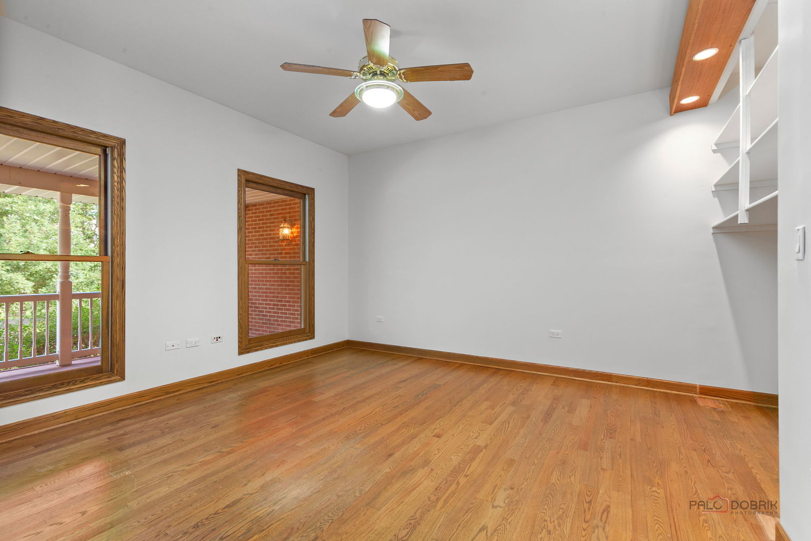 28232 North Gilmer Road Grayslake, IL 60030 - Photo 14 of 74 an empty room with wooden floor fan and windows