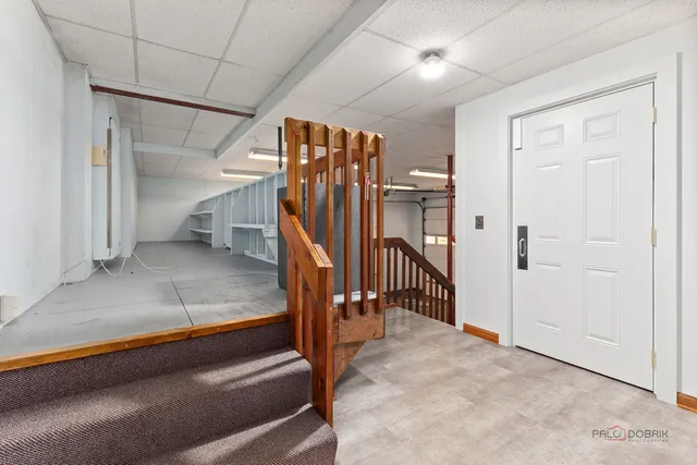 a bathroom with a toilet sink vanity and mirror