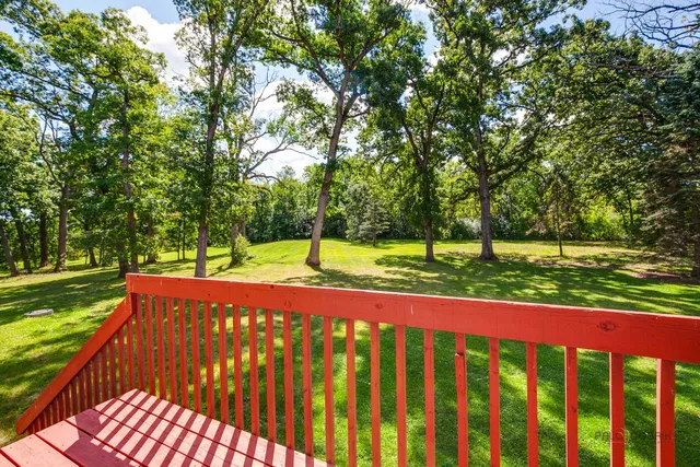 an aerial view of a golf course with parking space and lake view