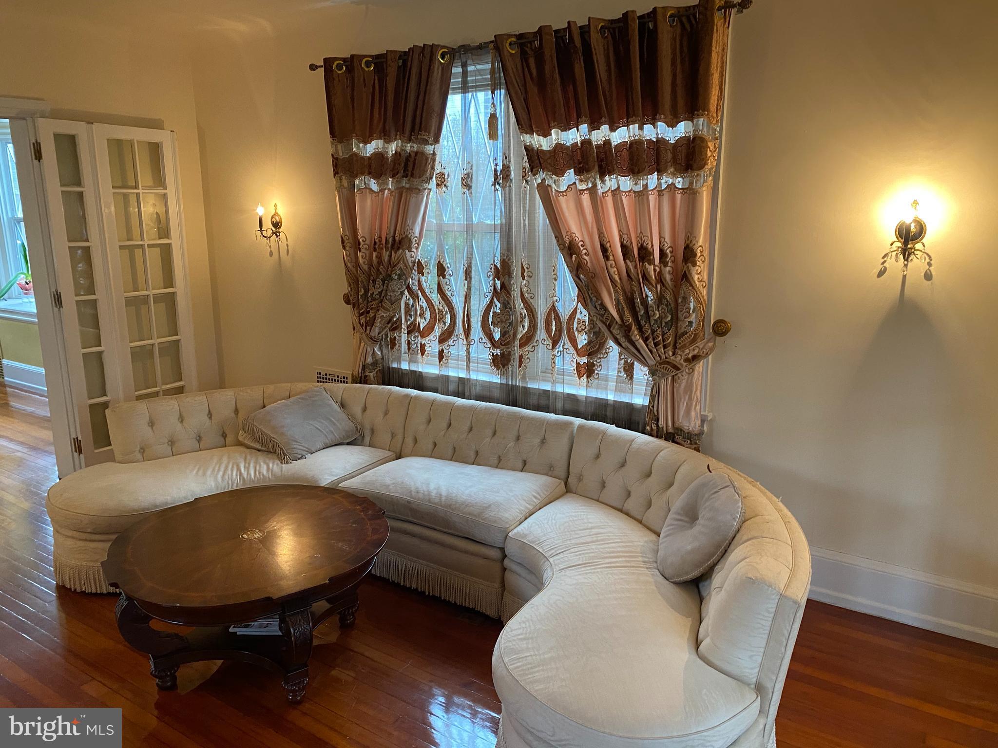 6358 Sherwood Road Philadelphia, PA 19151 - Photo 9 of 30 Living room with vintage brass sconces