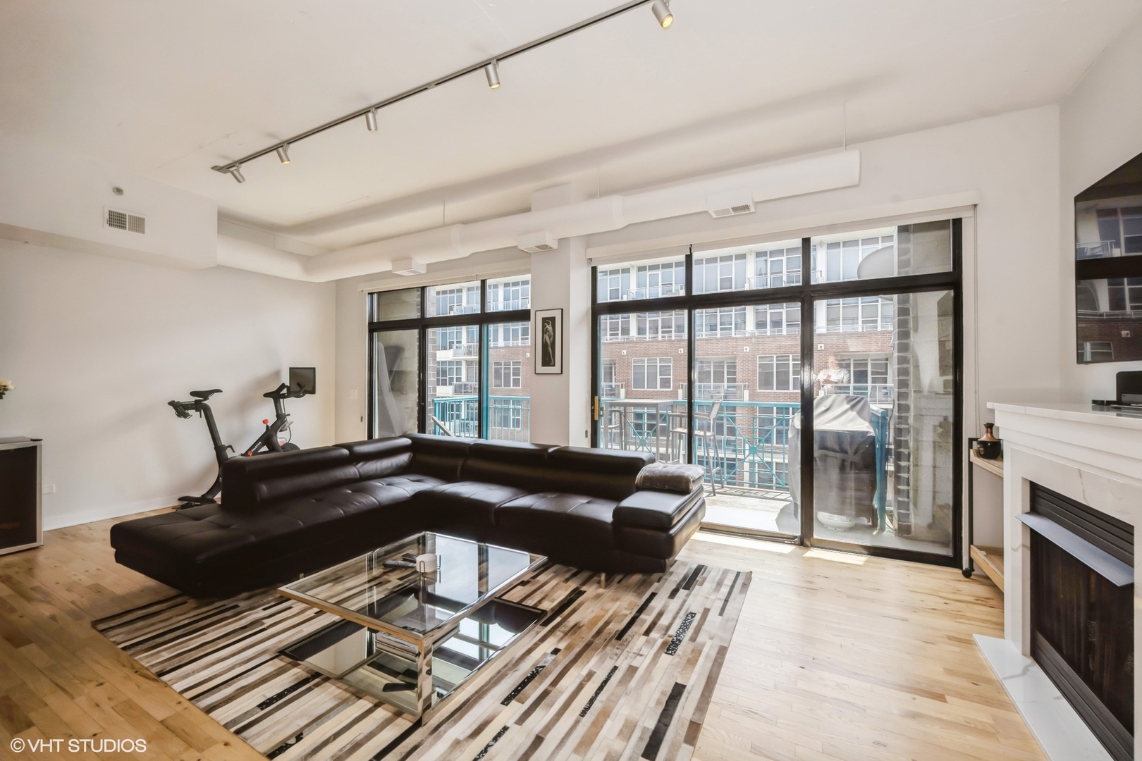 910 West Madison Street, Unit 802 Chicago, IL 60607 - Photo 3 of 13 a living room with furniture and a fireplace
