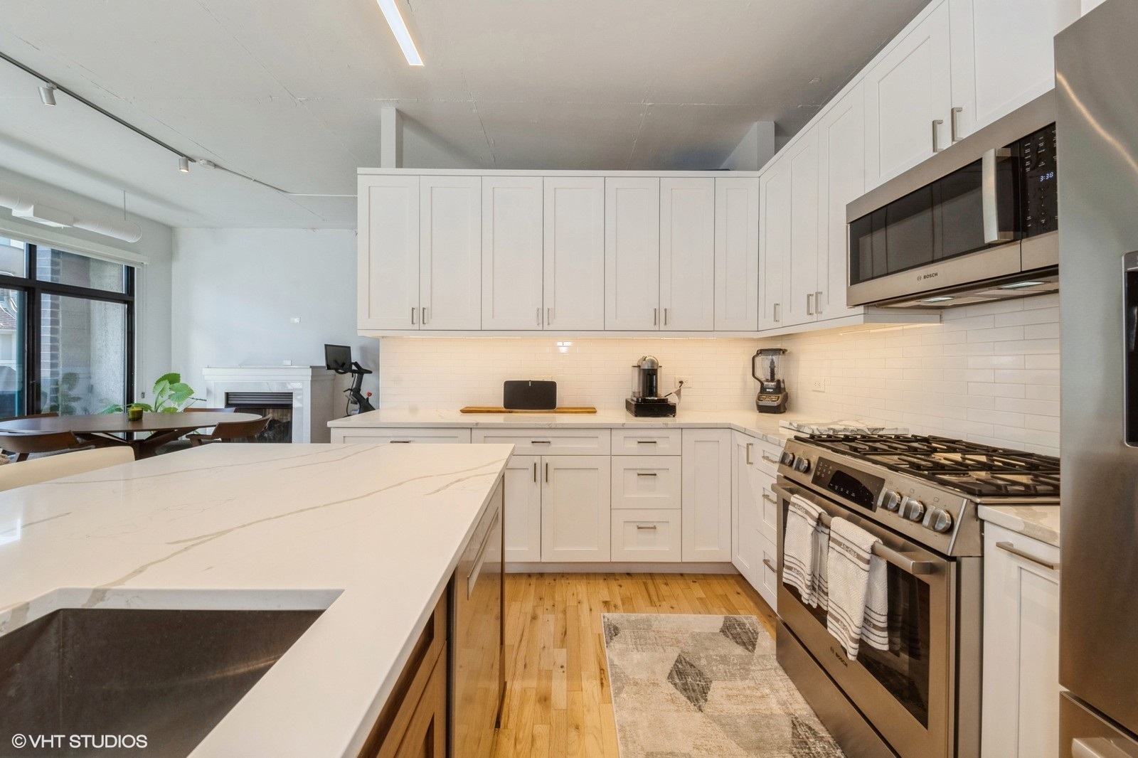 910 West Madison Street, Unit 802 Chicago, IL 60607 - Photo 4 of 13 a kitchen with stainless steel appliances a stove a sink and a microwave