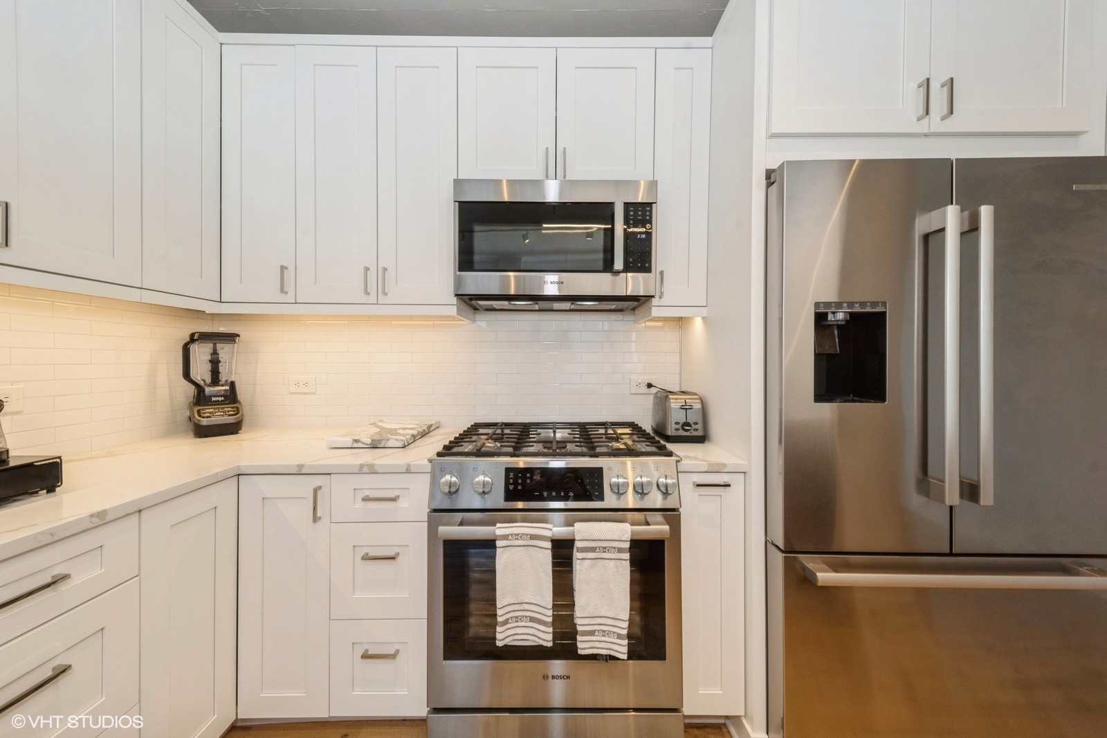 910 West Madison Street, Unit 802 Chicago, IL 60607 - Photo 5 of 13 a kitchen with white cabinets and stainless steel appliances