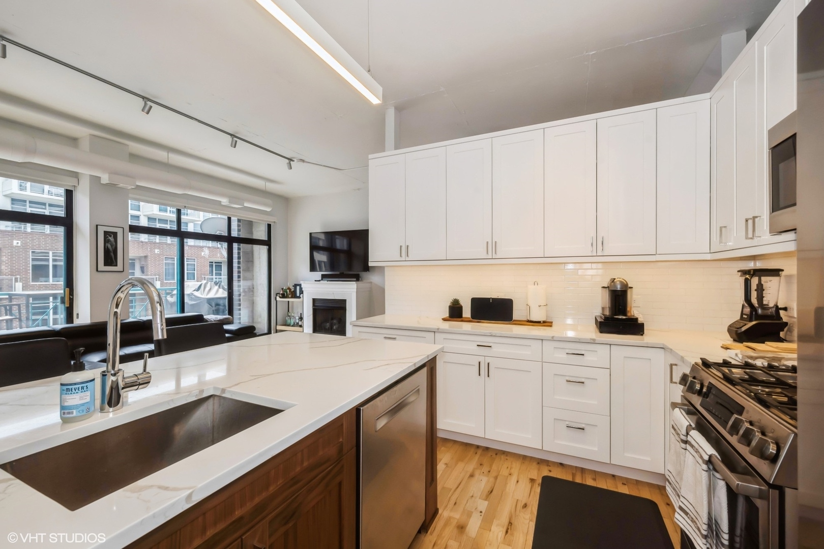 910 West Madison Street, Unit 802 Chicago, IL 60607 - Photo 6 of 13 a kitchen with a sink stove and cabinets