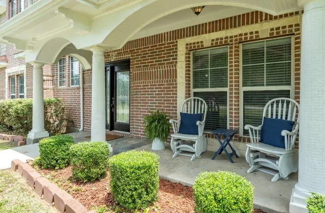 a front view of a house with outdoor seating