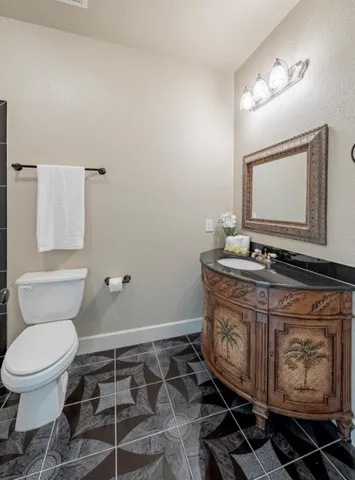 a bathroom with a toilet a sink and mirror