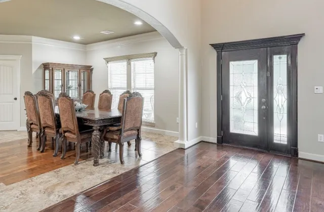 a view of a dining room with furniture and wooden floor