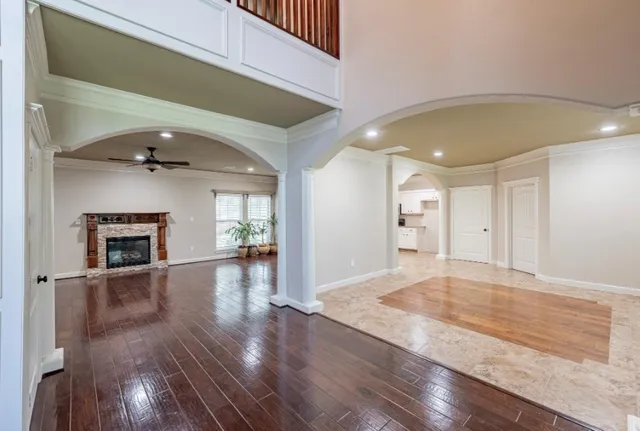 a view of a livingroom with wooden floor and a fireplace