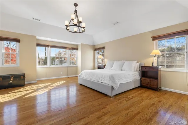 a spacious bedroom with a large bed and a window