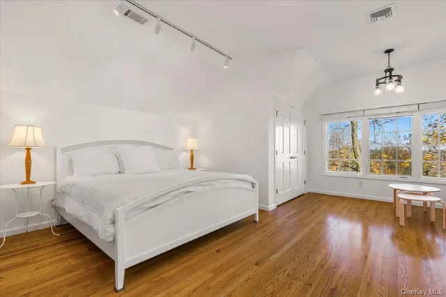 a bedroom with a large bed and a window