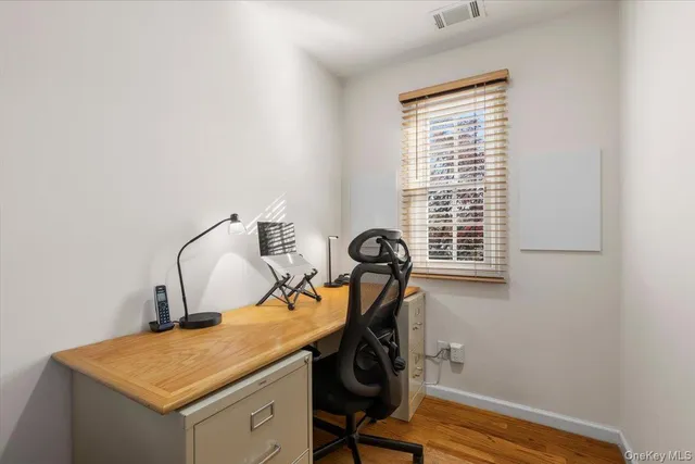a view of workspace with wooden floor windows