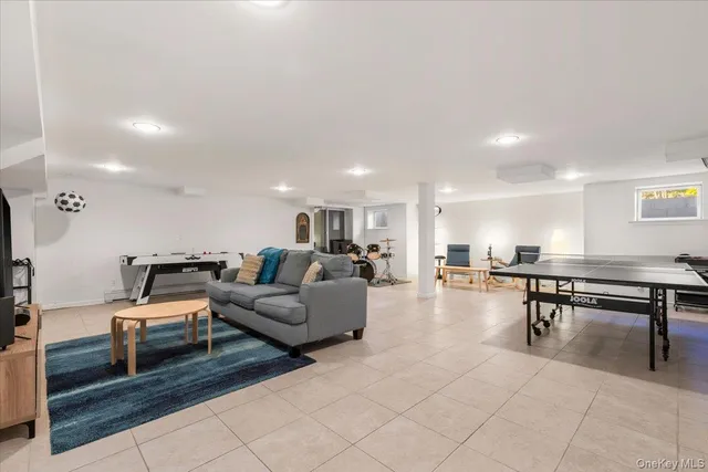 a living room with furniture a table and a potted plant
