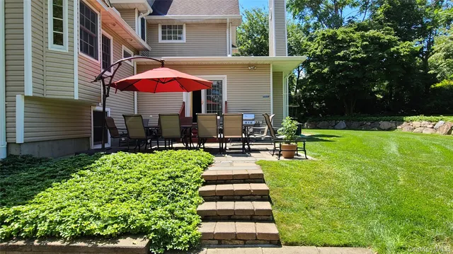 a view of a house with backyard porch and sitting area