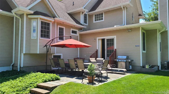 a view of a house with backyard sitting area and porch