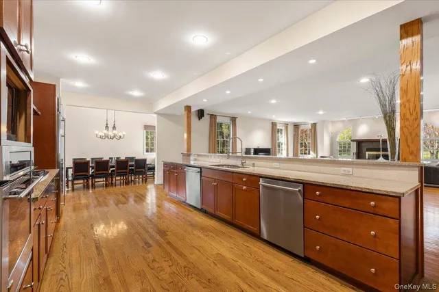 a view of a kitchen with dining table wooden floor and a view of living room