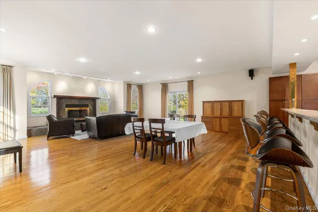 a living room with furniture flat screen tv and wooden floor