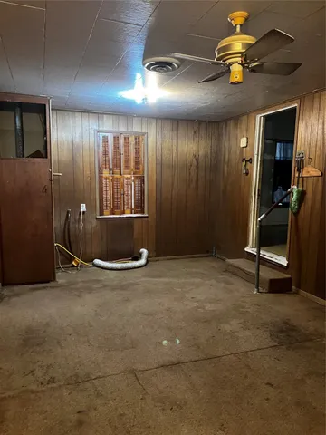 a view of empty room with projector and fan