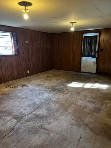 a view of an empty room with a kitchen