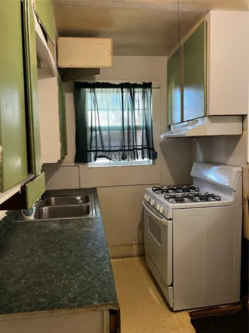 a kitchen with a stove and a sink