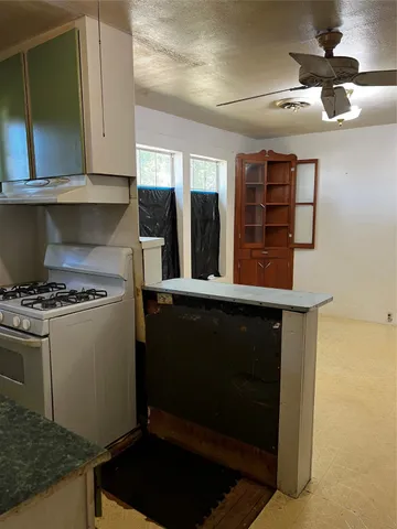 a kitchen with a stove and a microwave