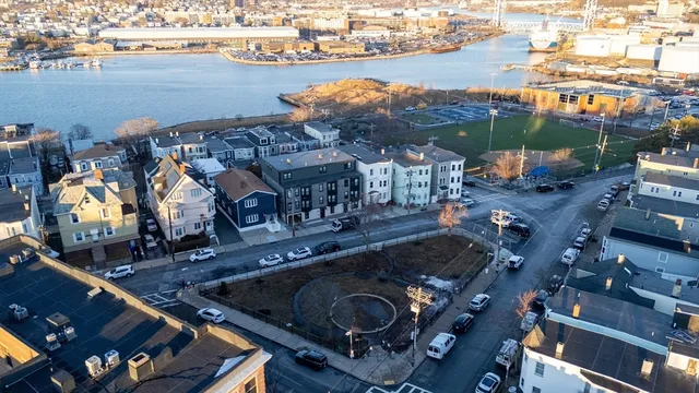 an aerial view of multiple houses with yard