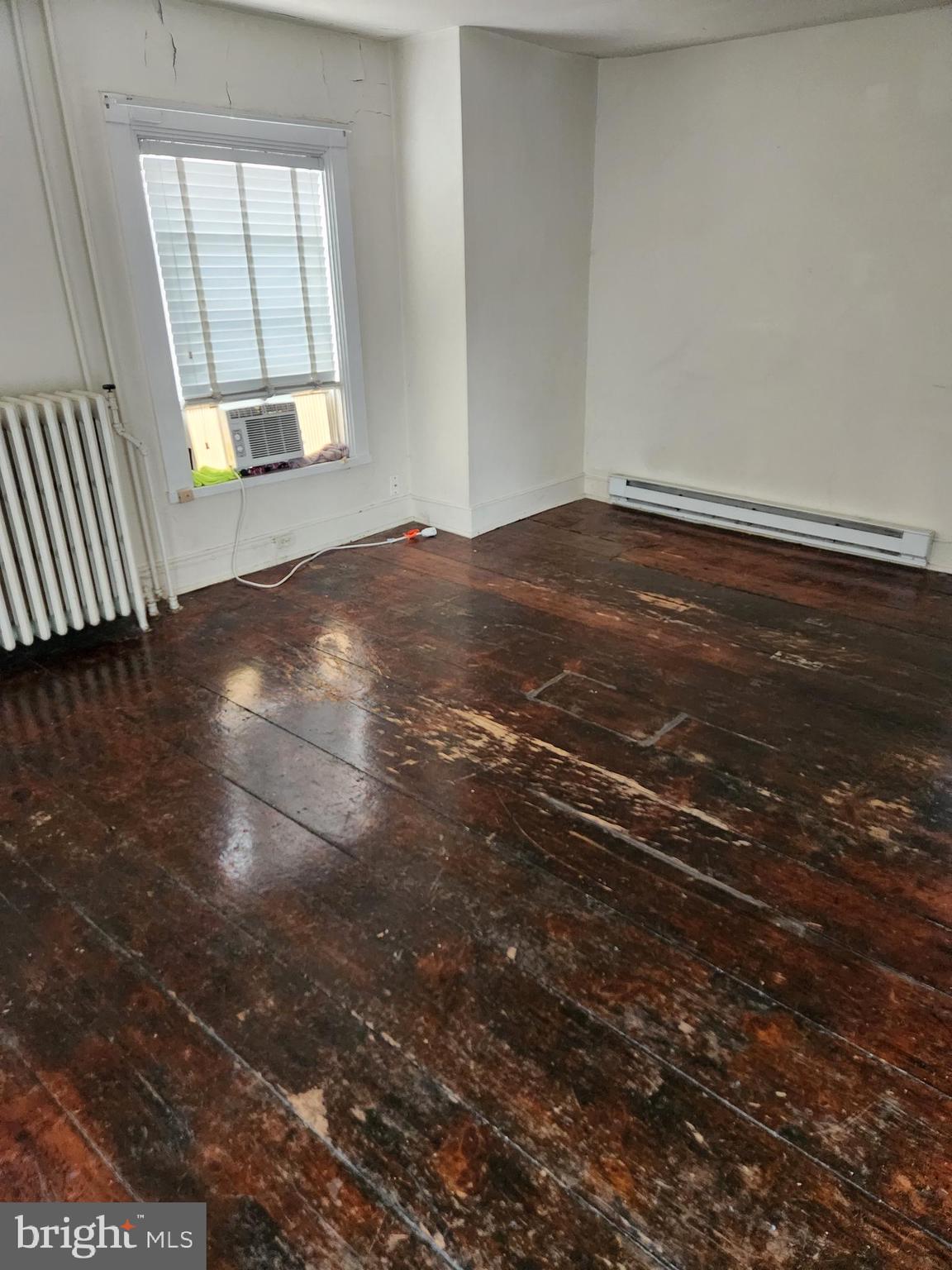 114 South Princess Street, Unit 3 Shepherdstown, WV 25443 - Photo 3 of 7 an empty room with wooden floor and windows