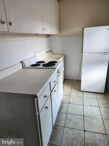 a kitchen with a stove cabinets and a refrigerator