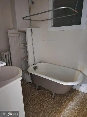 a white bath tub sitting next to a toilet