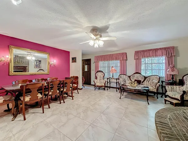 a living room with furniture a table and a large window