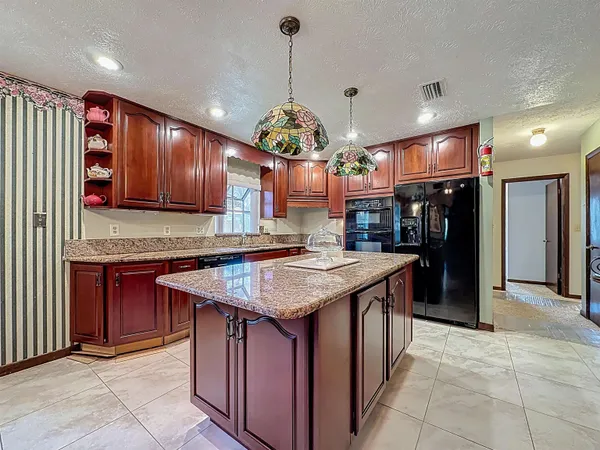 a bedroom with a large bed and a tv