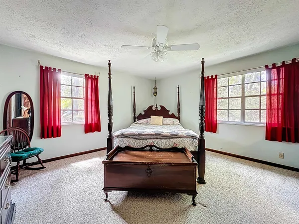 a living room with patio furniture and a large window