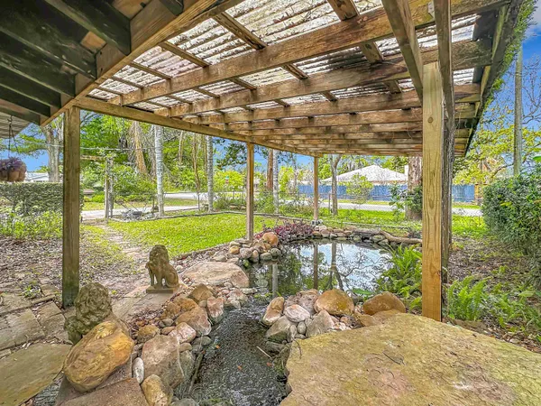 an aerial view of residential houses with outdoor space and trees