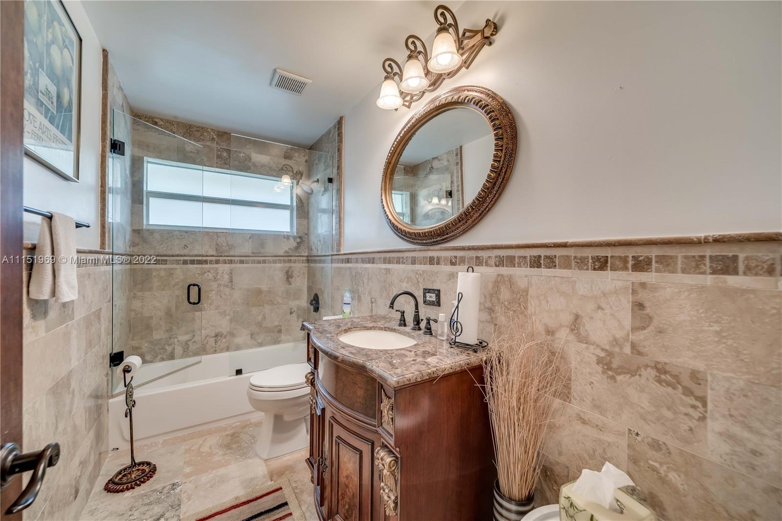 5001 Southwest 196th Lane Southwest Ranches, FL 33332 - Photo 23 of 72 a bathroom with a granite countertop sink a mirror and a bathtub