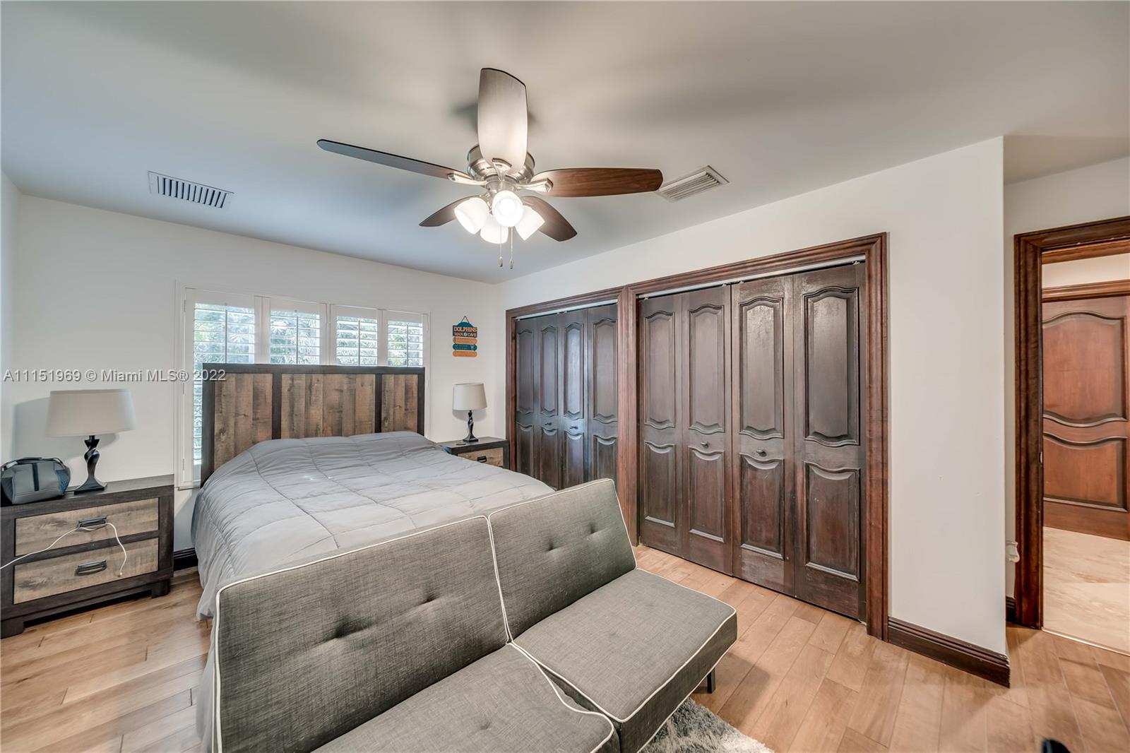 5001 Southwest 196th Lane Southwest Ranches, FL 33332 - Photo 40 of 72 a bedroom with a bed and a chandelier