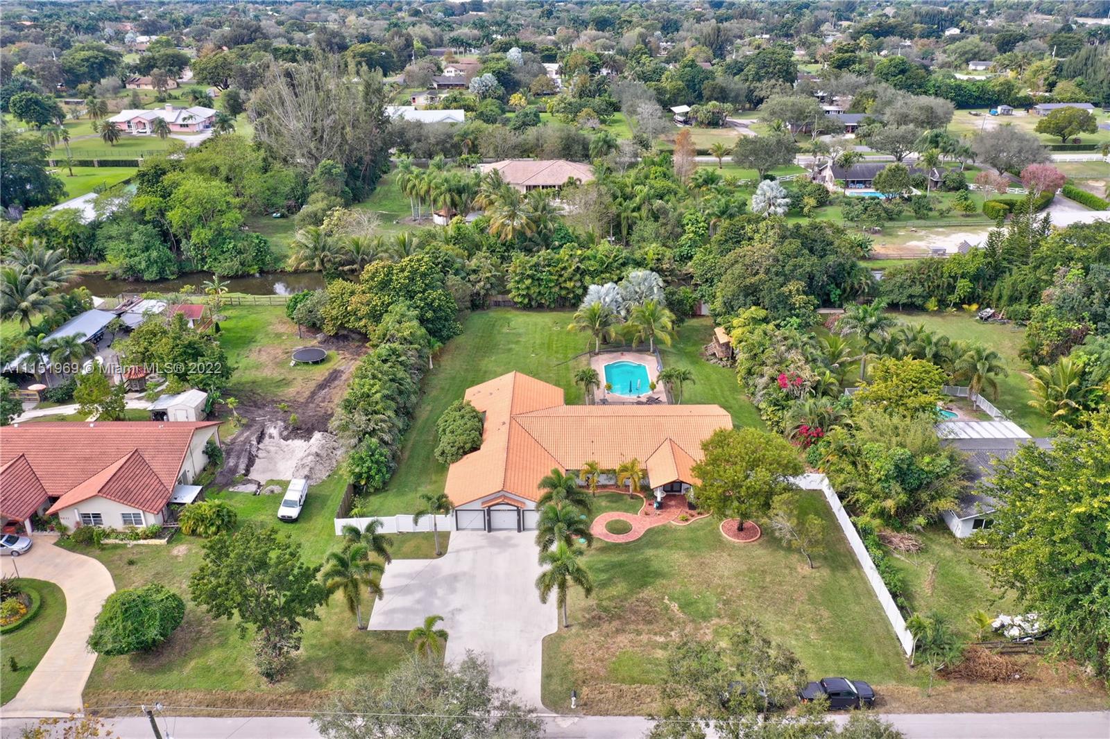 5001 Southwest 196th Lane Southwest Ranches, FL 33332 - Photo 64 of 72 an aerial view of a house with a yard and lake view