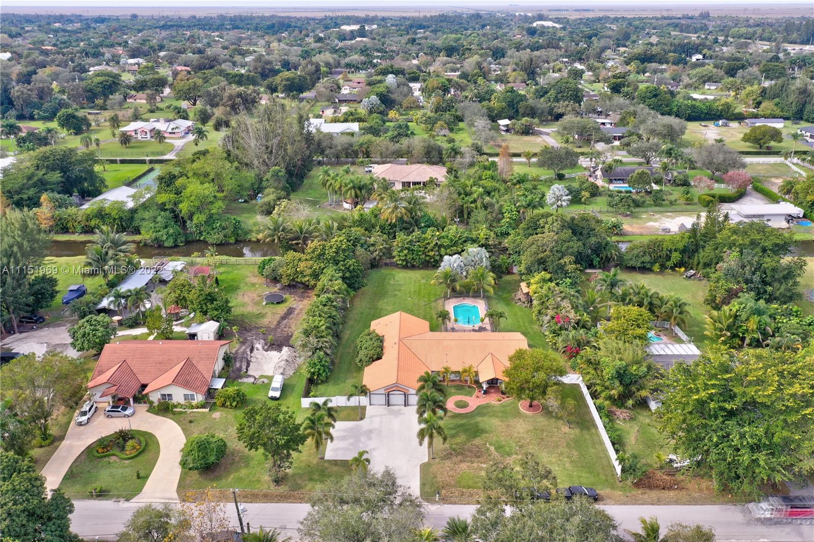 5001 Southwest 196th Lane Southwest Ranches, FL 33332 - Photo 65 of 72 an aerial view of a house with a yard and lake view in back