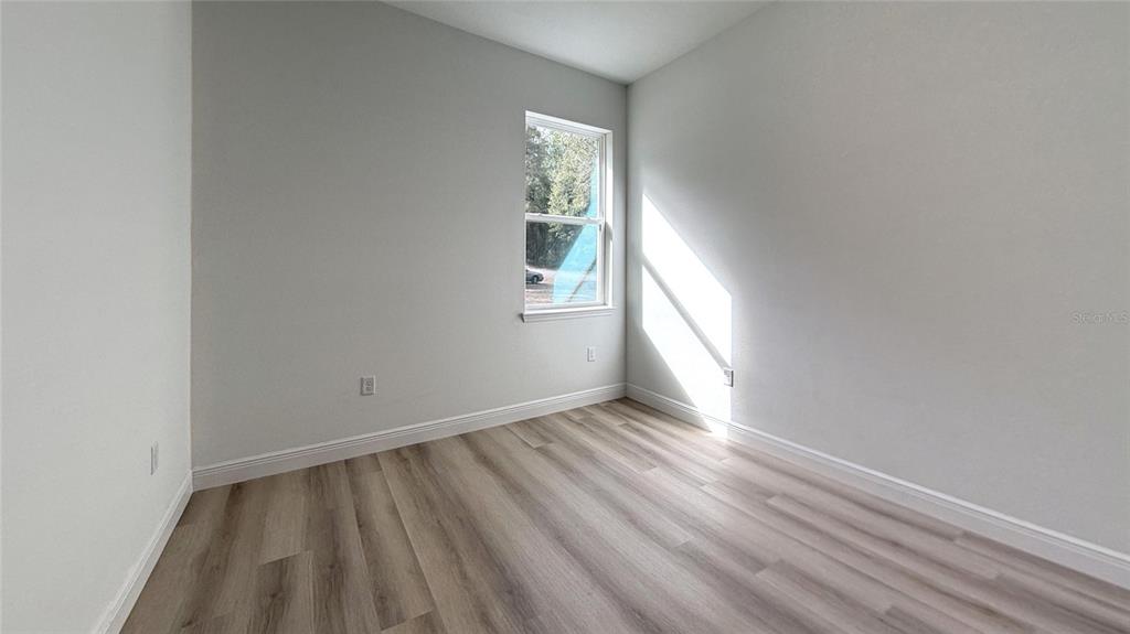 2018 West Magenta Drive Citrus Springs, FL 34434 - Photo 14 of 19 an empty room with wooden floor and windows