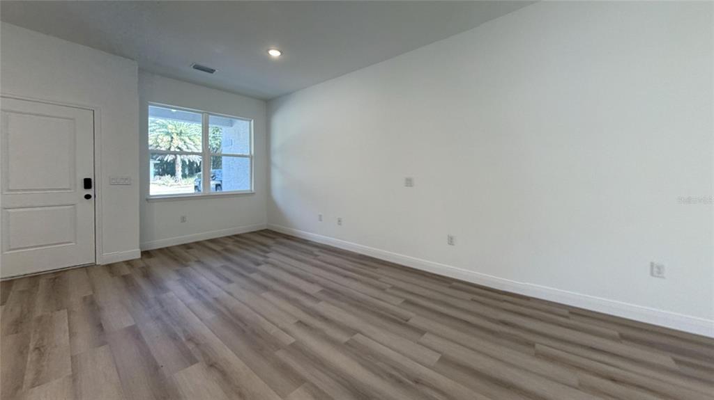 2018 West Magenta Drive Citrus Springs, FL 34434 - Photo 17 of 19 wooden floor in an empty room with a window