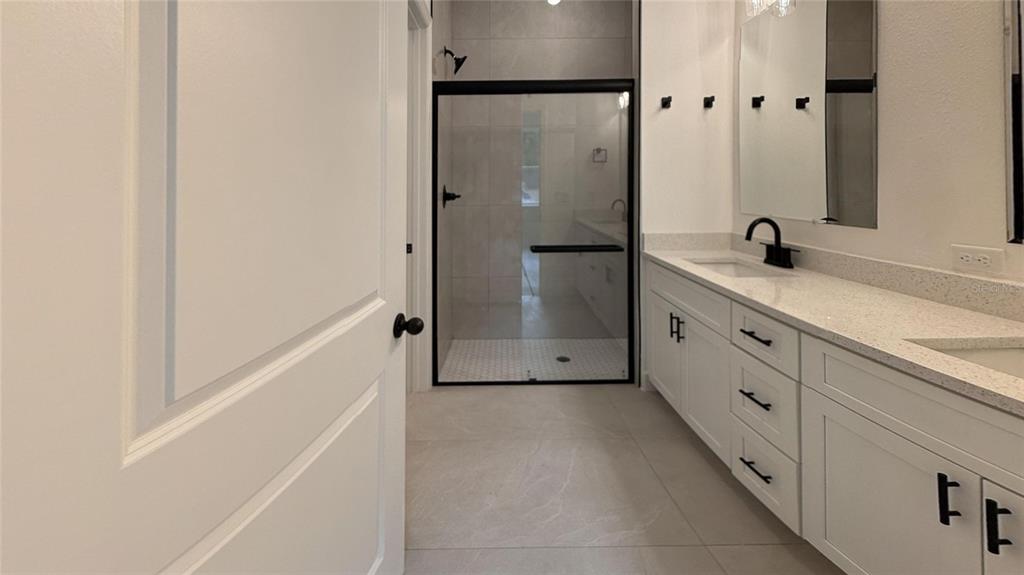 2018 West Magenta Drive Citrus Springs, FL 34434 - Photo 5 of 19 a bathroom with a double vanity sink a mirror and a bathtub