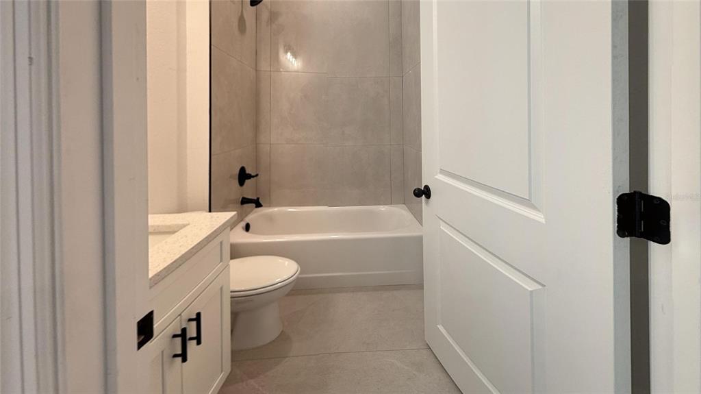 2018 West Magenta Drive Citrus Springs, FL 34434 - Photo 6 of 19 a bathroom with a granite countertop toilet a sink and bathtub