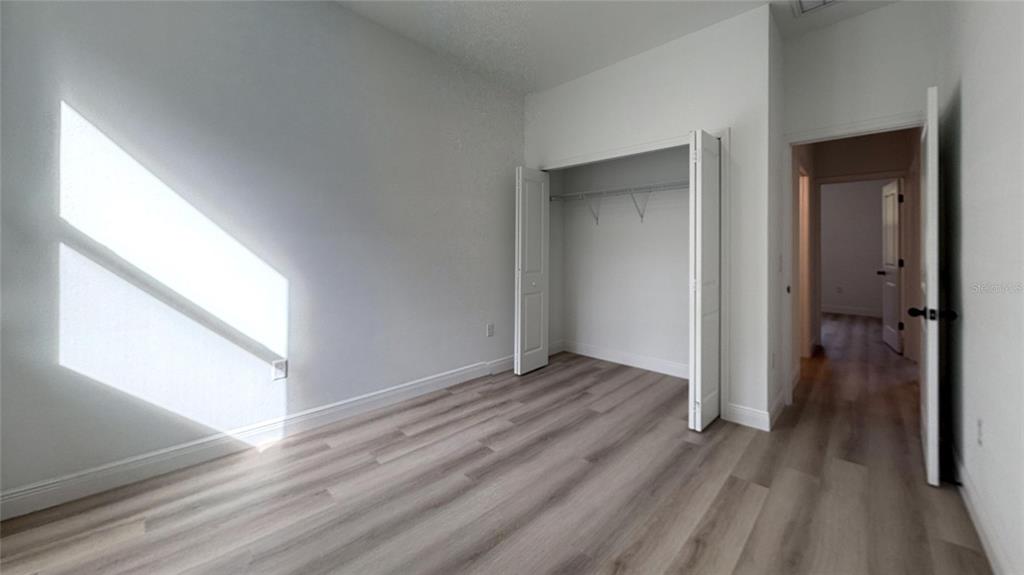 2018 West Magenta Drive Citrus Springs, FL 34434 - Photo 10 of 19 a view of an empty room with wooden floor and a window