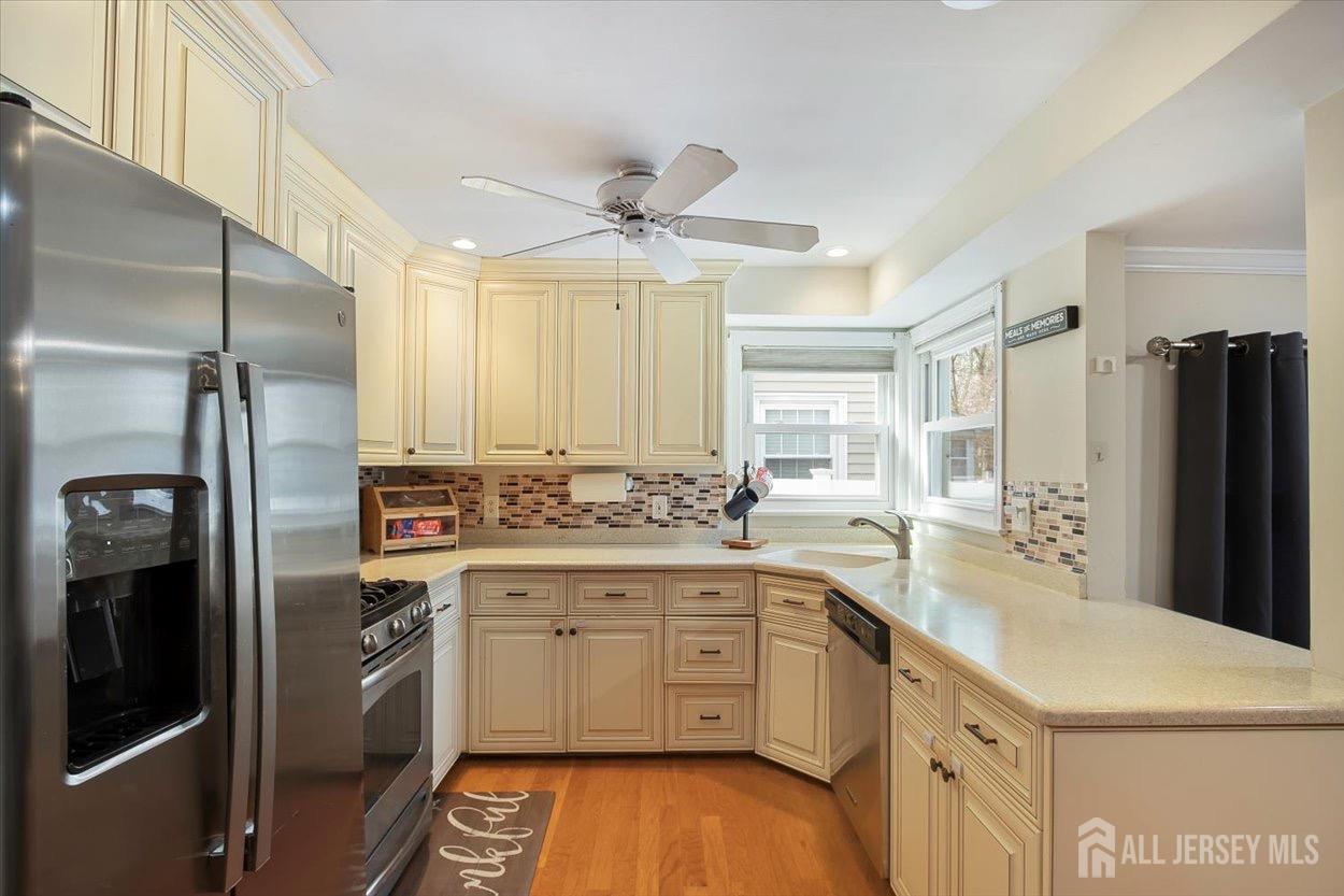580 Schuyler Way Union, NJ 07083 - Photo 12 of 30 a kitchen with stainless steel appliances a refrigerator sink and cabinets