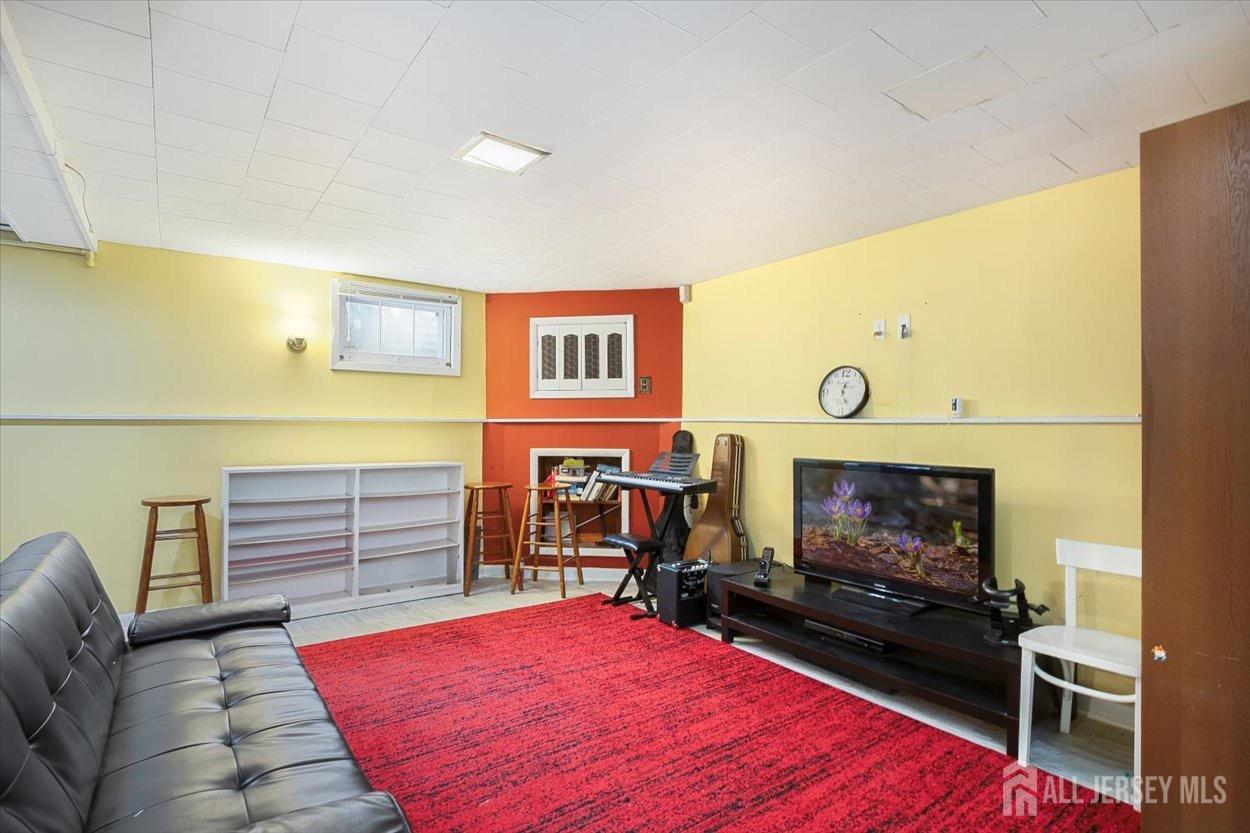 580 Schuyler Way Union, NJ 07083 - Photo 23 of 30 a living room with furniture flat screen tv and a fireplace