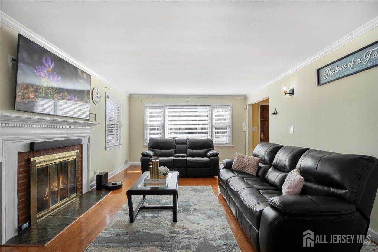 580 Schuyler Way Union, NJ 07083 - Photo 9 of 30 a living room with furniture wooden floor and a fireplace