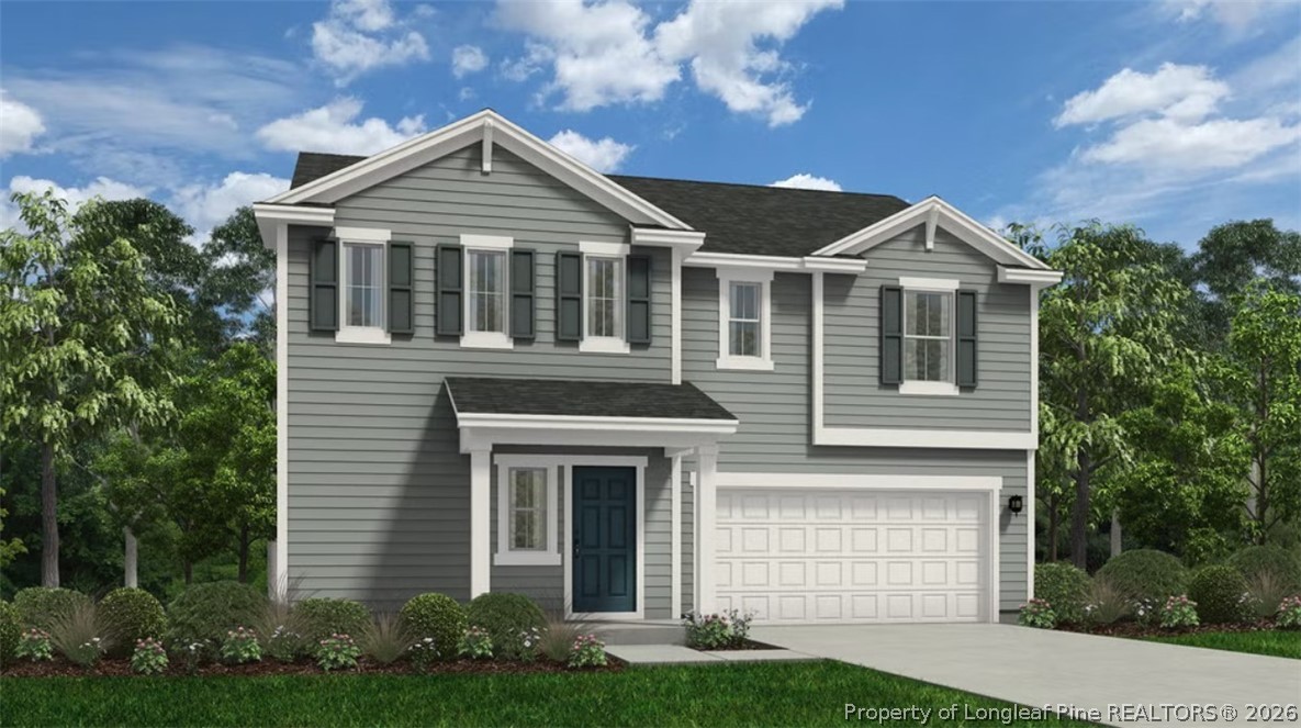 126 Portrush Lane Raeford, NC 28376 - Photo 1 of 3 a front view of a house with a yard and garage