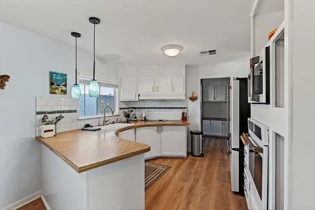 a kitchen with stainless steel appliances a sink stove and refrigerator