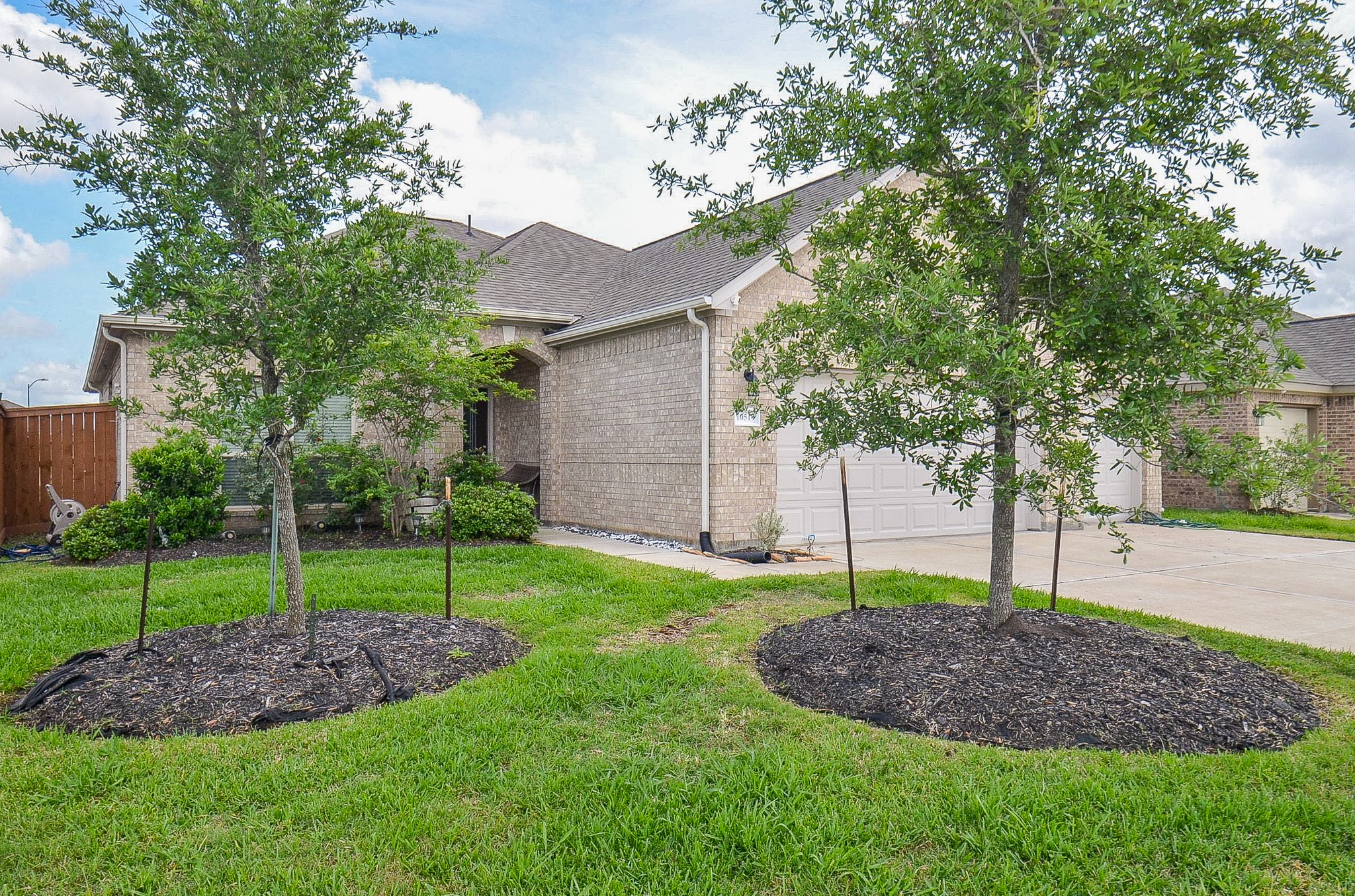 a view of a house with a backyard and tree