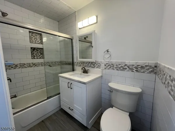a bathroom with a toilet sink and shower