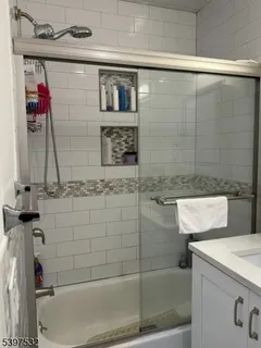 a bathroom with a bathtub and a shower